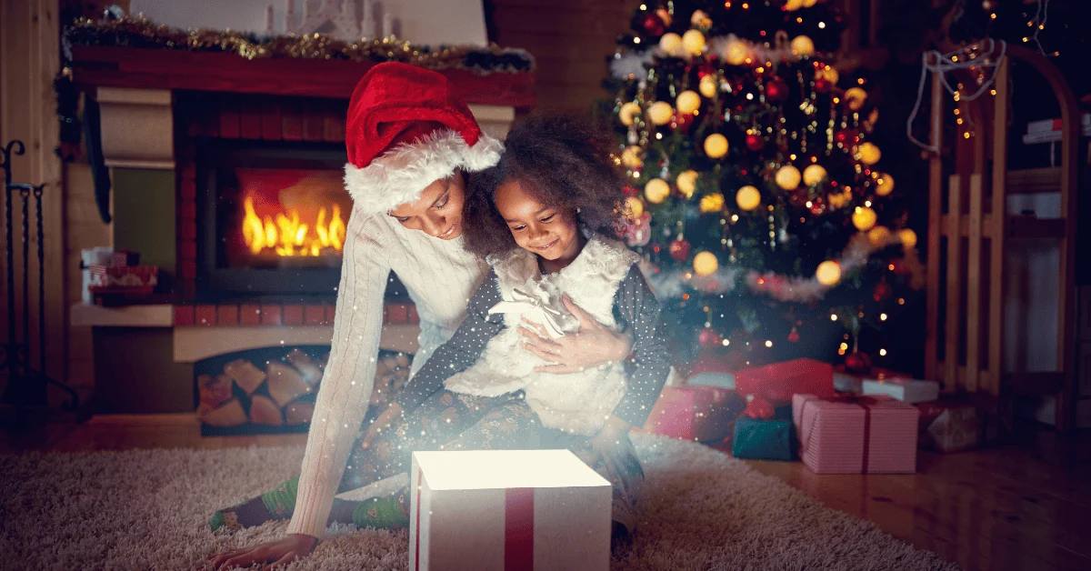 An adult and child opening a Christmas present