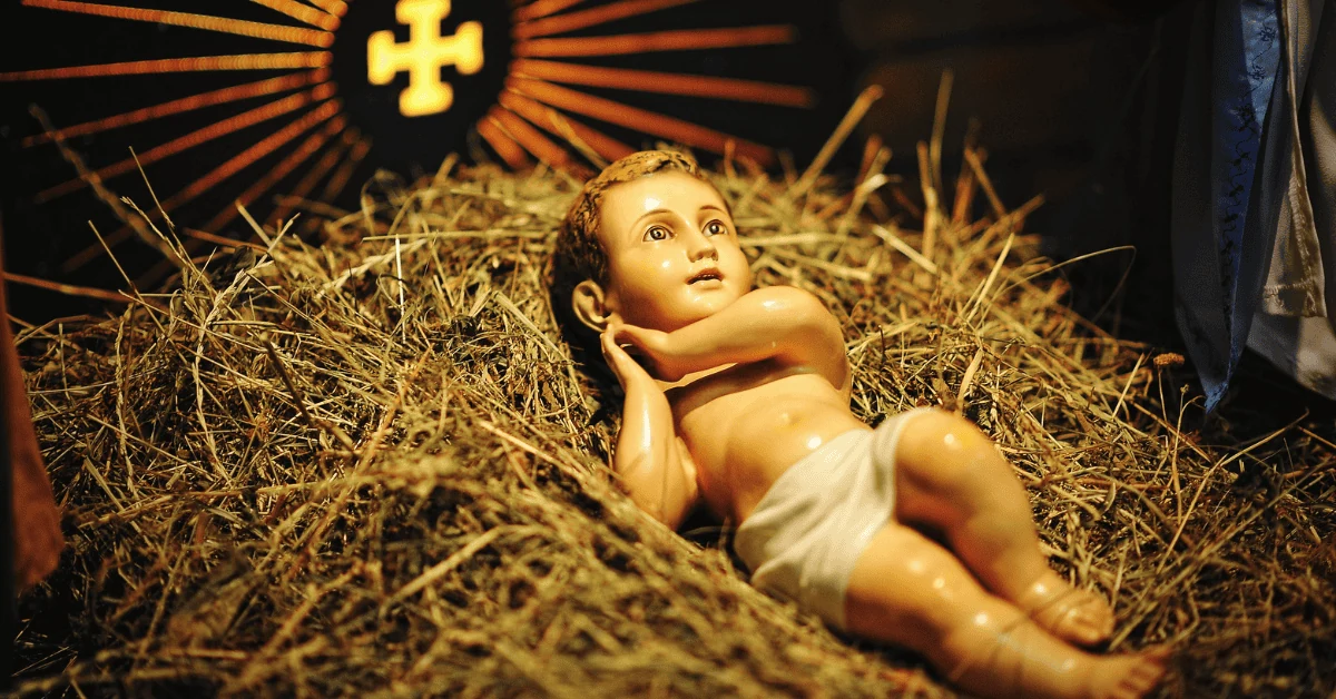 An infant Jesus statue resting on straw